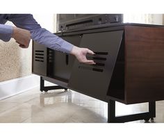 a person reaching for something on top of a cabinet