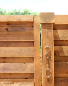 a wooden fence with the numbers 2050 written in silver on it's side