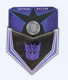 the back of a purple and black badge with a silver coin in it's center