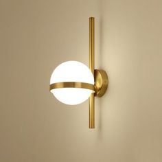 a wall light that is on the side of a wall with a white ball hanging from it