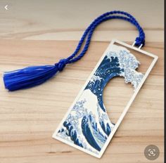 a keychain with an image of the great wave in blue and white on it