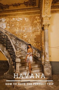 a woman standing at the top of some stairs