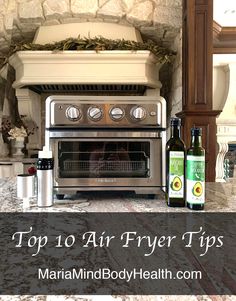 a stove top oven sitting on top of a counter next to two bottles of wine