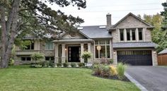 a large house with lots of windows and landscaping