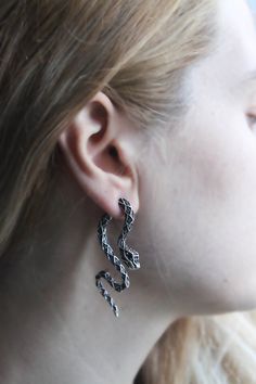 "An impressive snake earring hanging from both sides of the ear. You can choose to use either one-sided or double-sided. ♥ Measurements and size: -Made of silver plated metal alloy ♥ Size: 2.36 inch (6 cm) * 0.2 inch (0.5 cm) Since the earrings are magnificent enough, you can combine them with rings instead of necklaces. For example such a snake with a ring ❱❱❱❱❱❱❱ https://www.etsy.com/listing/1131655102/silver-snake-rings-boho-snake-rings-tiny?ref=listings_manager_grid For example such a snake with a necklace ❱❱❱❱❱❱❱ https://www.etsy.com/listing/1127832788/silver-snake-choker-snake-necklace?click_key=40da737e0c69c5241507f9b8a6b056380675af04%3A1127832788&click_sum=7fd462d2&ref=shop_home_feat_2&pro=1  T A K E  G O O D  C A R E  Please follow these tips to keep it longer time. --Keep it in a Snake-shaped Pierced Earrings Gift, Snake-shaped Pierced Earrings For Gift, Silver Snake Shape Metal Earrings, Silver Snake-shaped Metal Earrings, Silver Snake Shaped Metal Earrings, Snake-shaped Earrings For Pierced Ears As Gift, Silver Snake-shaped Earrings, Snake-shaped Single Earring As Gift, Single Snake Shape Earring As Gift