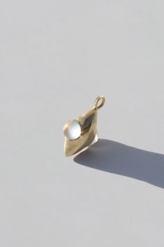 Cyril — Nazar Charm Modern Brass Drop Jewelry, Timeless Drop Jewelry With Polished Finish, Modern Metal Jewelry With Charms, Minimalist 14k Gold Pendant Charm, Timeless Pendant Charms Jewelry, White Timeless Metal Jewelry, Timeless White Metal Jewelry, Modern Brass Pendant Jewelry, Modern Brass Jewelry With Oval Link