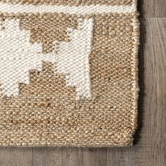 an area rug on the floor with white and brown accents, including a dog's head