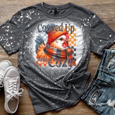 Fall Rooster Cooped Up and Cozy Farm Mom Animal Unisex Bleached Tee Color pictured: Dark Heather  2nd picture: Heather Orange  Super soft, breathable material! All Shirts are Gildan Softstyles  (65% polyester/35% cotton) Sizes Small, Medium, Large, XL, 2x, 3x Available  4x Available in dark heather, heather red, heather royal, heather purple, and heather orange, heather sapphire (message me to check other colors) Ships USPS First Class with tracking  Thank you for your support of our small busin Cozy Cotton T-shirt With Graphic Print, Cozy Fit Graphic Print Tops For Fall, Cozy Relaxed Fit T-shirt With Graphic Print, Cozy Graphic Print Tops For Fall, Cozy Short Sleeve Tops For Fall, Winter Short Sleeve Tops With Letter Print, Short Sleeve Tops With Letter Print For Winter, Cozy Graphic Print T-shirt For Fall, Graphic Tee With Relaxed Fit For Winter