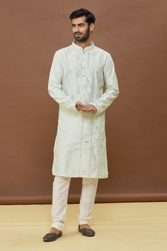 Sea green kurta with mirror work and mandarin collar. Paired with off white churidar.
Components: 2
Pattern: Embroidered
Type Of Work: Mirror
Neckline: Mandarin
Sleeve Type: Full
Fabric: Kurta: Dola Silk, Churidar: PV Cotton
Color: Green
Other Details: 
Mirror work
Occasion: Mehendi and Puja - Aza Fashions White Churidar, Silk Churidar, Green Mirror, Types Of Work, Green Mirrors, Mirror Set, Fashion App, Mirror Work, Churidar