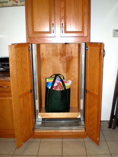 an open cabinet with a bag in it