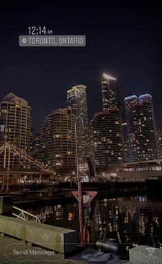 the city is lit up at night by the water