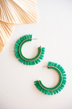 The Gracie Rattan Fan Hoops are the perfect accessory to elevate your tropical vacation style. These colorful rattan hoop earrings exude a playful and vibrant charm that complements any summertime outfit. Handcrafted with intricate attention to detail, each earring features a unique fan-shaped design, adding a touch of whimsy and exotic flair. Made from sustainable rattan material, these lightweight hoops provide a comfortable fit without compromising on style. Whether you're strolling along the Green Hoop Earrings For Beach, Green Hoop Earrings For The Beach, Green Small Hoop Earrings For Summer, Small Green Hoop Earrings For Summer, Green Beaded Hoop Earrings For Beach, Trendy Green Hoop Earrings For Beach, Trendy Hoop Earrings For Vacation, Handmade Green Hoop Earrings For Beach, Summer Vacation Hoop Earrings