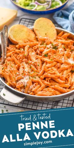 a pan full of penne alla vodka with bread on the side and text overlay reading tried & tested penne alla vodka