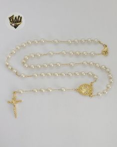 Description: -Our Lady of Charity Pearls Rosary Necklace. -Material: 18k Gold Overlay (BGO). -Pearls: 5.5mm. -Available in Size: 22". Elegant Gold Rosary For Anniversary, Elegant Gold Anniversary Rosary, Elegant Pearl Rosary With 8mm Beads, Elegant Pearl Rosary With Round Beads, Gold Pearl Jewelry With 8mm Beads, Classic Gold Pearl Necklace With 8mm Beads, Brazilian Gold, Pearl Rosary, Rosary Necklace