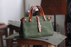 This is the holy grail in unisex carryall totes: practical and perfect in every way. This tote was built to endure. Load it up, bring it everywhere. This bag a thoughtful, minimalist design, with an seamless balance of utility and style. * High Quality Waxed Canvas Fabric - Waterproof * Premium Tanned Leather 2.0 mm - 2.2 mm * Stainless Metal Hardware * Durable Polyester Thread Sewing * 150 cm Neck Strap * 2 Front Pocket * 1 Front Kangaroo Pocket * Size : 24 x 18 x 16 cm * Color : Olive Canvas Tool Bag, Boot Chains, Carryall Tote, Tool Bag, Holy Grail, Waxed Canvas, Neck Strap, Pocket Size, Electronic Items