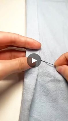 someone is stitching something on the white sheet