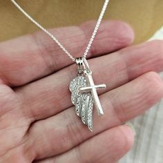 Solid 925 Sterling Silver Angel wing charm necklace- A wonderful Sympathy gift for the loss of a loved one Sterling Silver Angel Wing with CZ's measures 28mm (just over 1 inch) Sterling Silver Cross measures 25mm (1 inch)  Sterling Silver 0.8mm Cable or Box Chain with spring ring clasp.  (You choose style and length using the drop down menu) Comes beautifully packaged - ready to give as a gift or keep for yourself! Add a Swarovski Birthstone dangle charm using this link: https://forevermemorydes Sterling Silver Cross Charm Necklace For Anniversary, Spiritual Sterling Silver Charm Necklaces For Keepsake, Sterling Silver Necklace For Remembrance, Sterling Silver Charm Necklace For Memorial, Spiritual Sterling Silver Charm Necklace For Keepsake, Sterling Silver Cross Pendant Necklace For Memorial, Silver Angel Wings Jewelry Gift, Angel Wings Pendant Jewelry Gift, Silver Angel Wings Necklace As Gift