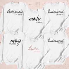 four bridesmaid sweatshirts on a wooden surface