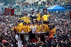 a large group of people in yellow shirts are on top of a giant round object