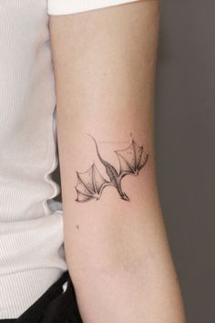 a woman's arm with a tattoo design on the back of her left arm