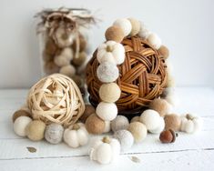 some balls are sitting on the table next to each other and one is made out of wood