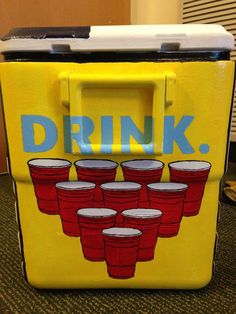 a yellow cooler with red plastic cups on it and the word drink painted on it