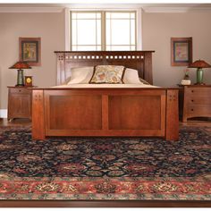 a large bed sitting on top of a rug in a bedroom