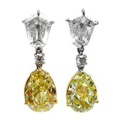 Sophisticated and classic, these yellow diamond drop earrings add a gorgeous pop of sparkle and color. Two beautifully matched fancy light yellow pear shape diamonds (5.44 carats total) dangle from two white kite diamonds (totaling 1.59 carats) and round diamonds (0.12 carats total) to create a stunning set of earrings. The yellow pear shape diamonds are set in 18K yellow gold, and the white diamonds are set in platinum. Yellow Diamond Earrings, Light Yellow Diamond, Yellow Diamond Earring, Diamond Chandelier Earrings, Round Diamond Earrings, Fancy Light, Pear Earrings, Vintage Drop Earrings, Gold Chandelier Earrings