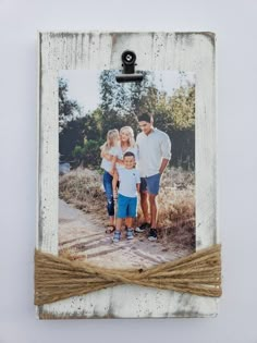 an old photo frame with twine around it