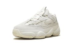 The adidas Yeezy 500 Kids “Bone White” is the youth sizing of the chunky lifestyle design of the popular Yeezy 500 series.  Released in a number of clean tonal looks, the 500 has gained traction with those who prefer a bulky silhouette.  The upper features an elegant combination of a soft Bone White mesh base with smooth suede overlays on the toe, eyelets, mid-panel, and heel.  The sole of the adidas Yeezy 500 may look familiar to fans of early adidas Kobe models; a 2000s Feet You Wear midsole with traction pattern evokes a vintage feeling to the sneaker.  The kids sizing of the adidas Yeezy 500 “Bone White” was released on August 24th, 2019. Yeezy 500 Bone White, Adidas Shoes Yeezy, Adidas Baby, Yeezy 500, Adidas Kids, Yeezy Shoes, Stadium Goods, Bone White, Lifestyle Design