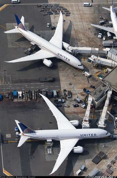 an aerial view of several airplanes parked at the airport terminal, including one for united airlines