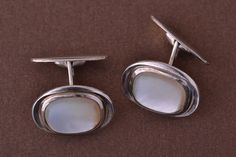 An elegant pair of vintage 1950's cufflinks. 835 silver set with mother-of-pearl. Marked: ''835''. Dimensions: 20mm x 15.6mm x 4.35mm. Weight: 9.56g Condition: Excellent Square Mother Of Pearl Sterling Silver Cufflinks, Elegant Polished Cufflinks For Anniversary, Elegant Polished Finish Cufflinks For Anniversary, Formal White Gold Mother Of Pearl Earrings, Elegant White Cufflinks With Polished Finish, Modern White Cufflinks For Formal Occasions, Classic White Cufflinks With Polished Finish, Timeless White Cufflinks For Formal Occasion, Polished Mother Of Pearl Jewelry For Formal Occasions