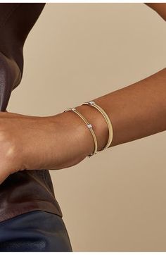 Designed to skillfully adapt to the curves of the wrist, this slender cuff is crafted from hand-coiled strands of 18-karat gold. The versatile piece is punctuated with three diminutive stations dusted in pavé diamonds. 6 3/4" inner circumference; 1/8" width; 1/8" square stations Box clasp with hinge closure Total diamond weight: 0.09ct Color: G Clarity: VS1 Made in Italy Diamond Guide