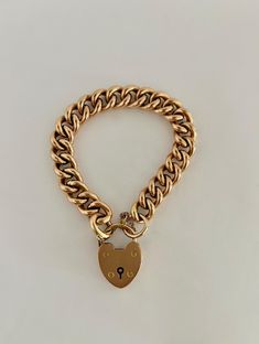 Antique Victorian Gold Heart Lock Curbchain Bracelet - 15k. During the Victorian Era, the heart lock bracelet was a symbol of love and fidelity. The heart lock is simple and classic, made of solid 15k gold. MARKINGS AND HISTORY: Marked 15k gold, with British hallmarks as shown in photo. (Please reach out if more information is needed!) ERA: Circa 1880's OVERALL CONDITION: This beautiful bracelet is in excellent condition overall, all links are in great condition and the heart lock is functioning perfectly. The bracelet also has a safety chain, adding extra security. There are some small surface scratches on the lock. Classic Gold Lock Jewelry, Classic Gold Jewelry With Lock Detail, Timeless Gold Curb Chain Bracelet As Gift, Timeless Gold Curb Chain Bracelet For Gift, Timeless Gold Bracelet With Curb Chain For Gift, Classic Formal Bracelet With Heart Charm, Classic Bracelets With Heart Charm, Classic Yellow Gold Heart Charm Bracelet, Classic Gold Heart Bracelet With Charm