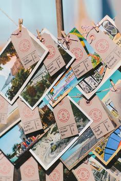 many postcards are hanging on a clothes line