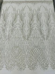 a white table cloth with silver sequins on it