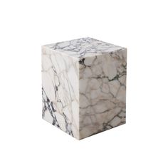 a white and black marble block on a white background