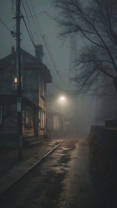 an empty street at night in the fog