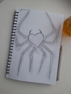 a drawing of a spider man with two legs and a heart in the middle, on top of a notebook