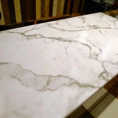 a white marble counter top in a kitchen