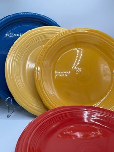 four different colored frisbees sitting next to each other