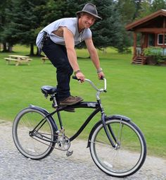 a man riding on the back of a black bike