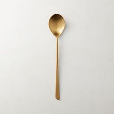 a gold spoon on a white background