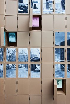 several cardboard boxes are stacked on top of each other with pictures attached to the sides