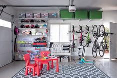 there is a bike rack in the garage with two children's toys on it