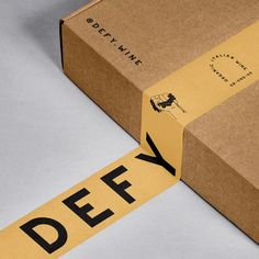 an open box with a yellow tape on it and the word defy taped to it