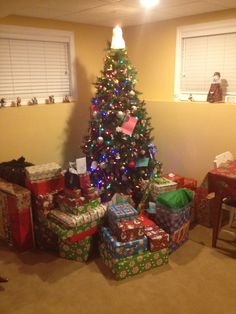 a christmas tree with presents under it