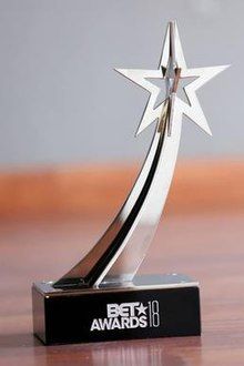 a silver star trophy sitting on top of a wooden table