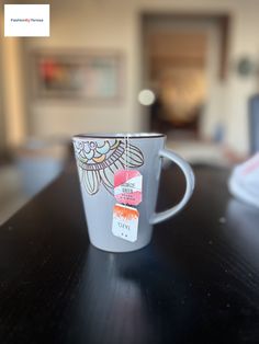 a coffee cup sitting on top of a wooden table