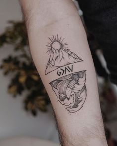 a man's arm with a tattoo on it that says vag and mountains